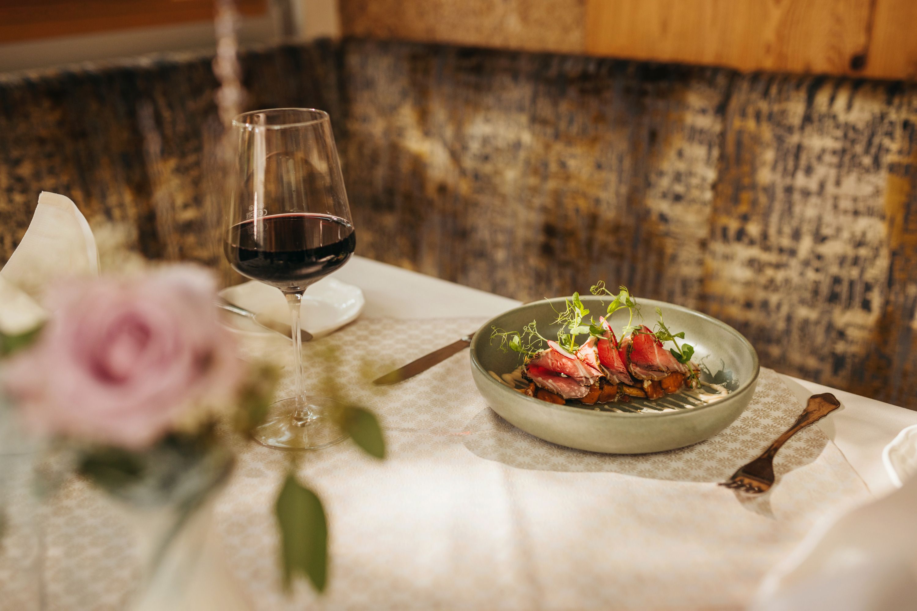 Elegant dish with red wine in a stylish restaurant ambience.