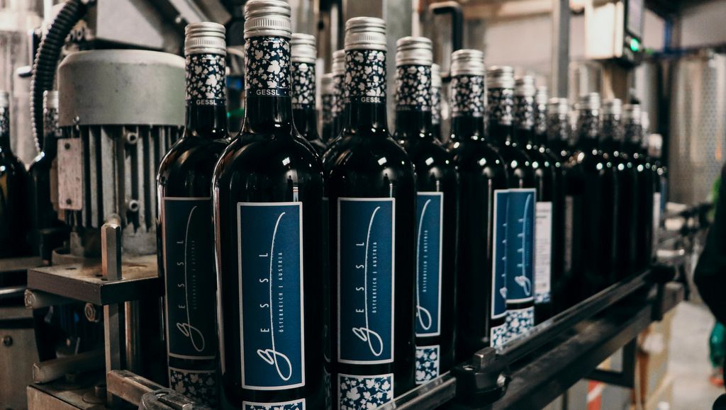 Wine bottles on a conveyor belt in a bottling plant.
