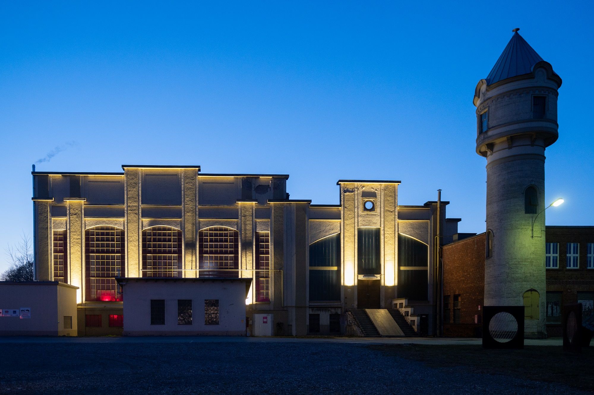 Illuminated building in St. Pölten at dusk with tower on the right.