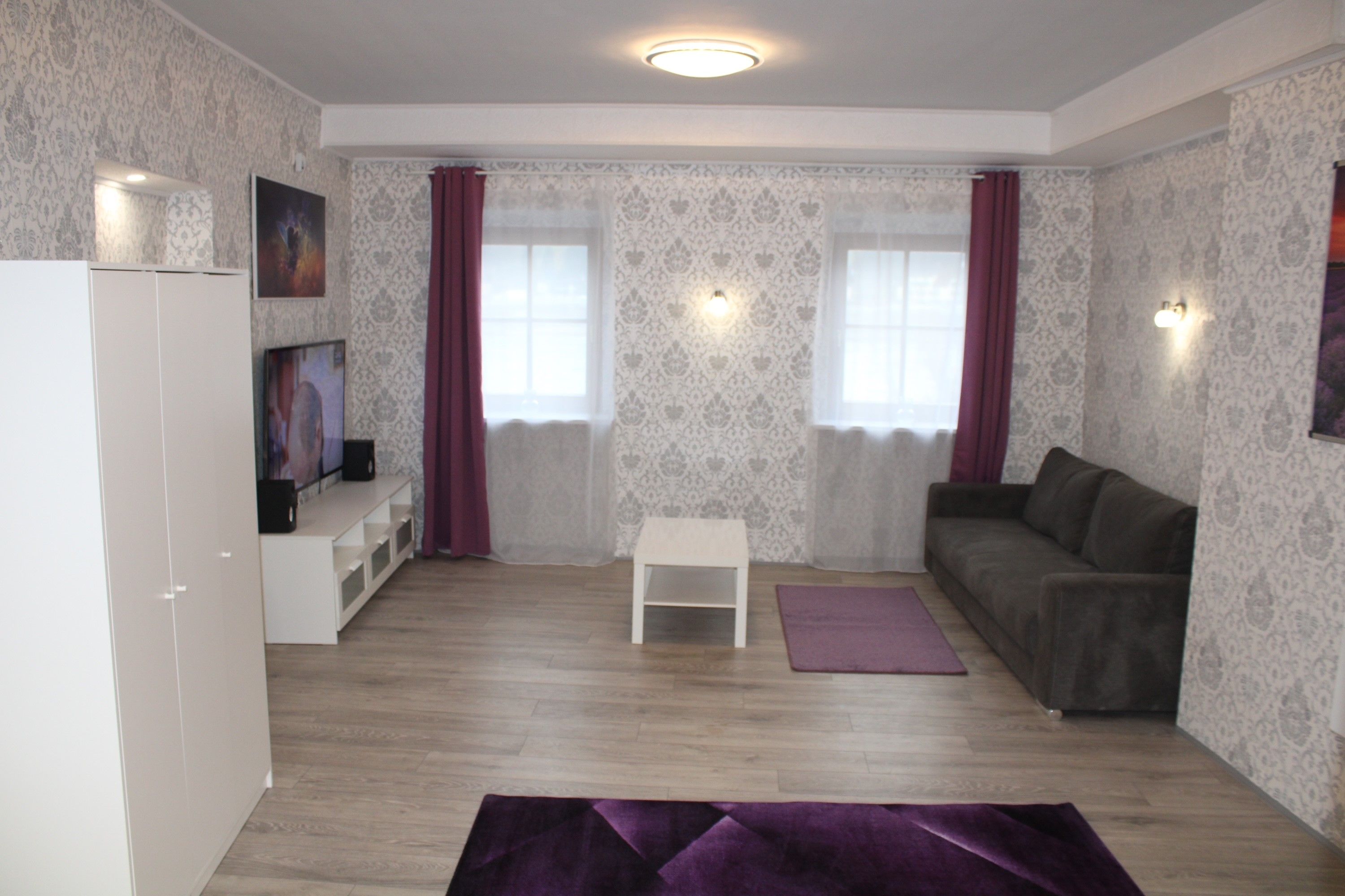 Living room with white furniture and gray couch