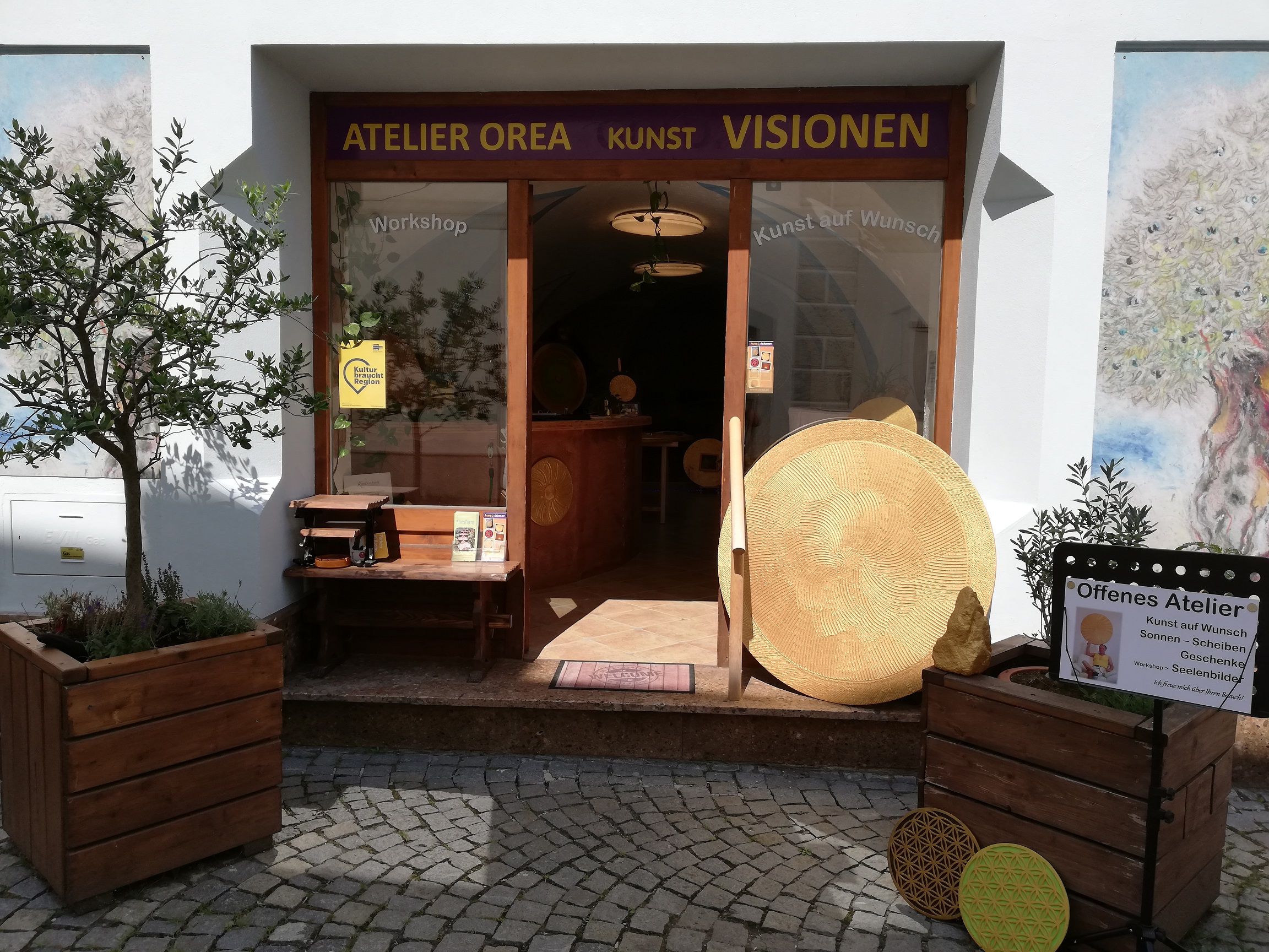 Entrance to the Orea studio with works of art and plants.