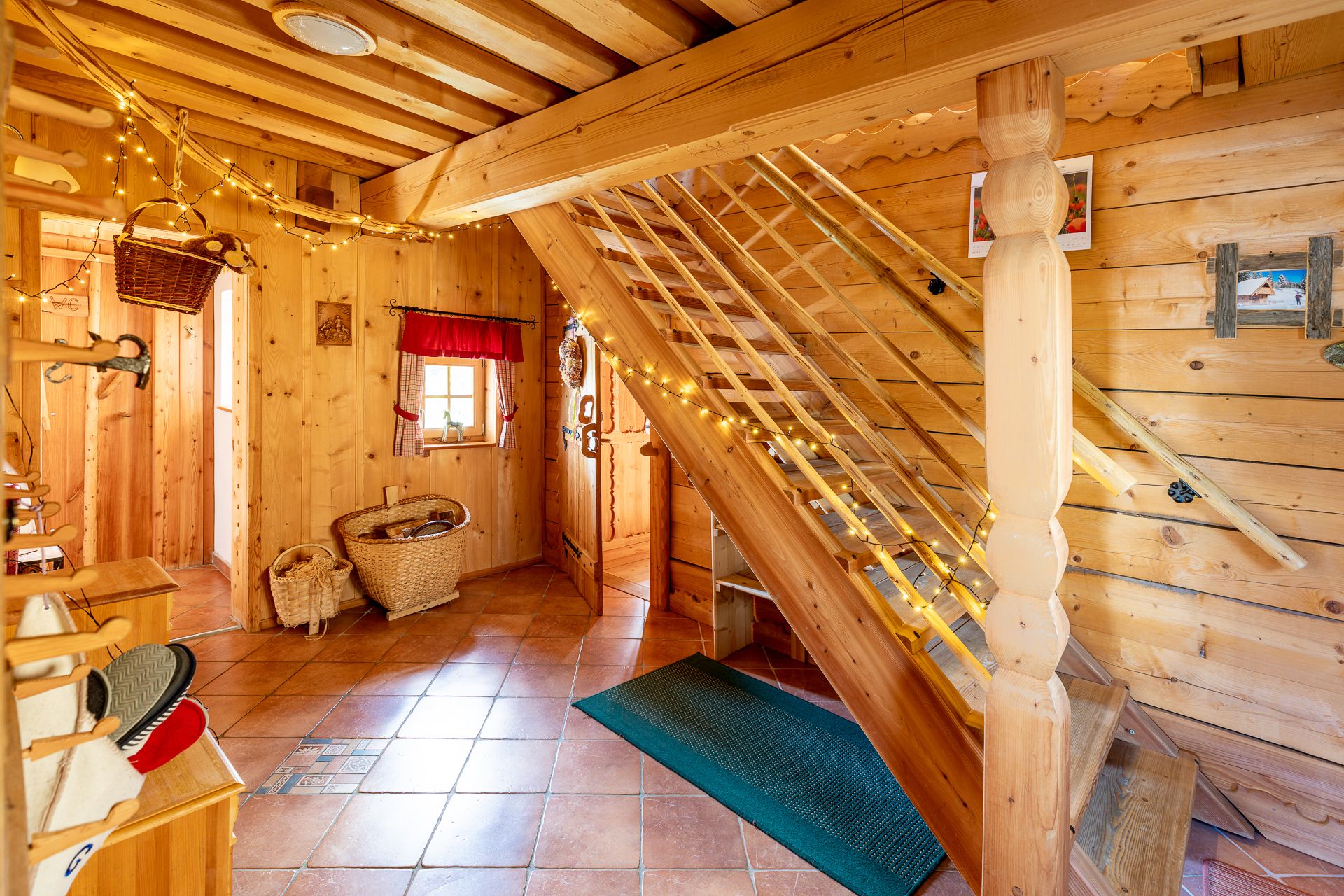 Room with wood paneling, tiled floor, a staircase and decoration.