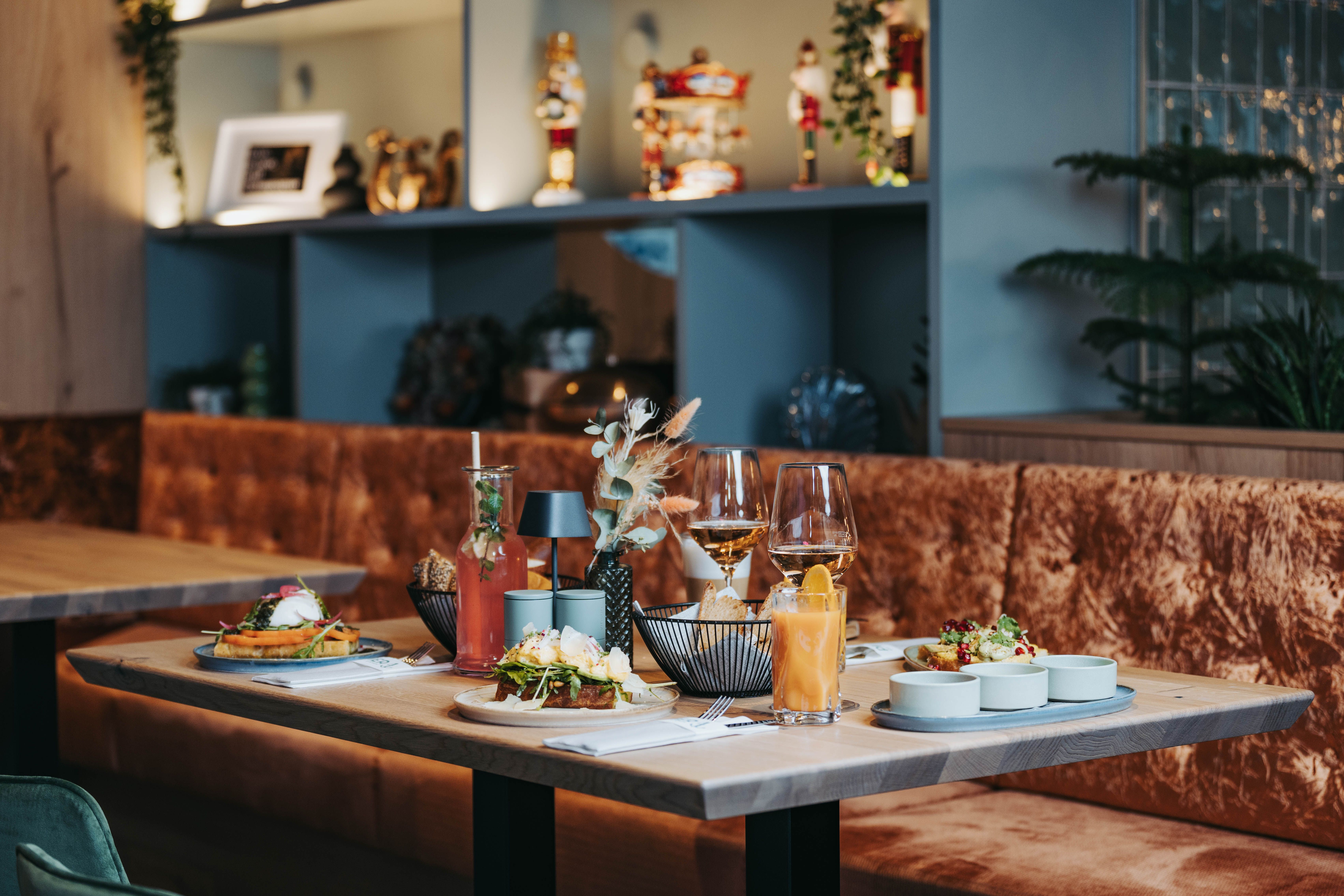 Set table with food and drinks in a stylish restaurant.