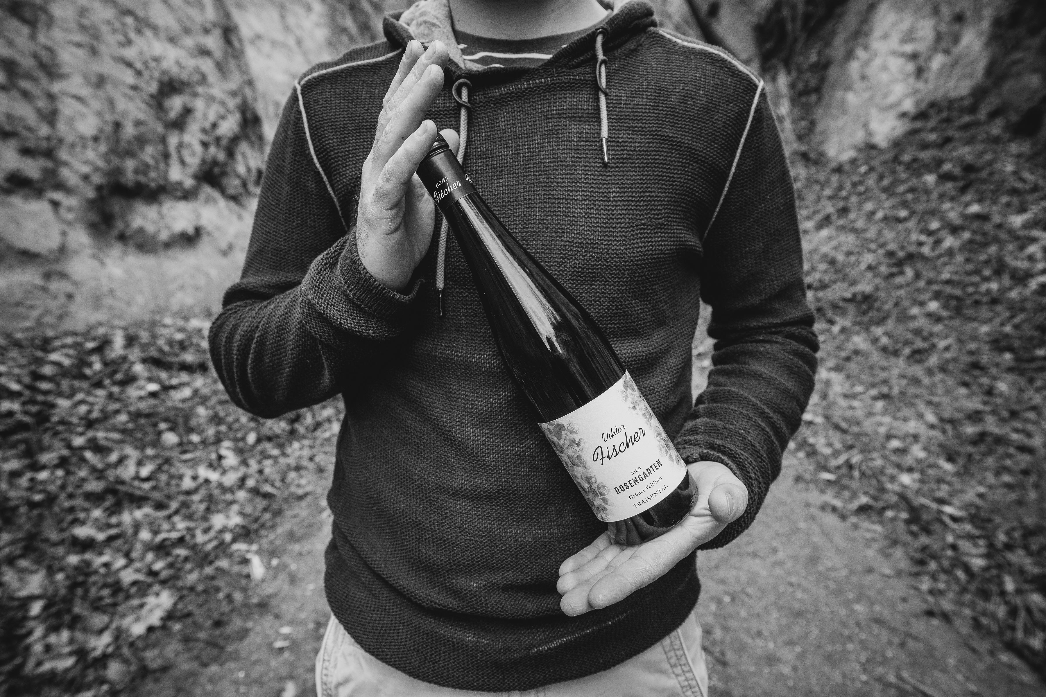 Winegrower presents a bottle of wine 