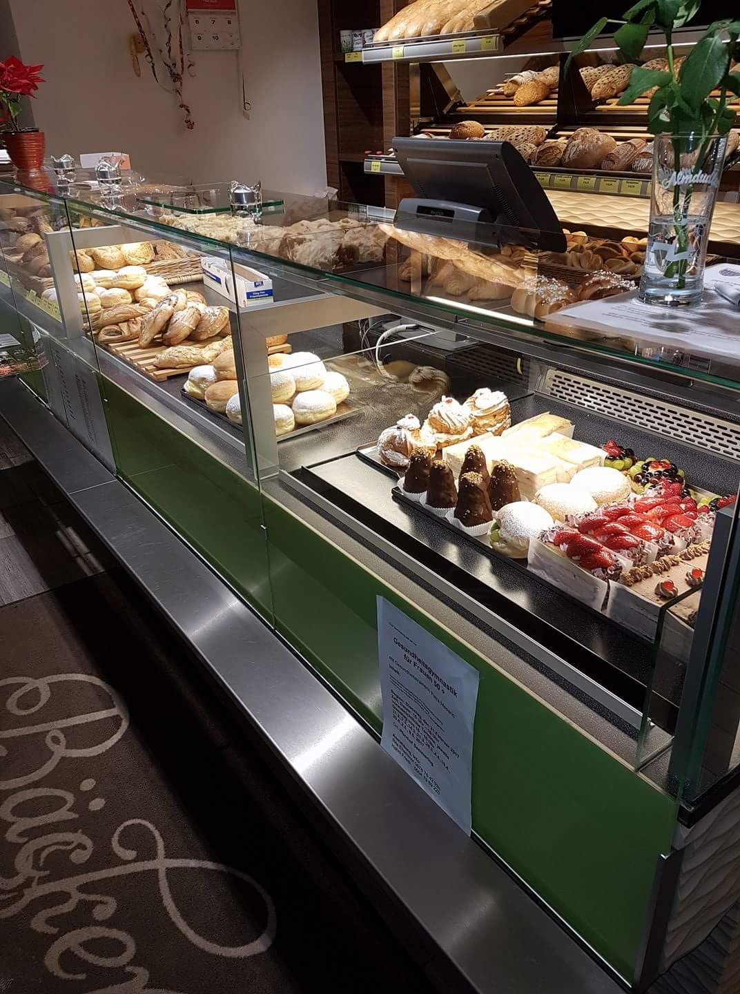 A bakery counter with various baked goods and cakes.