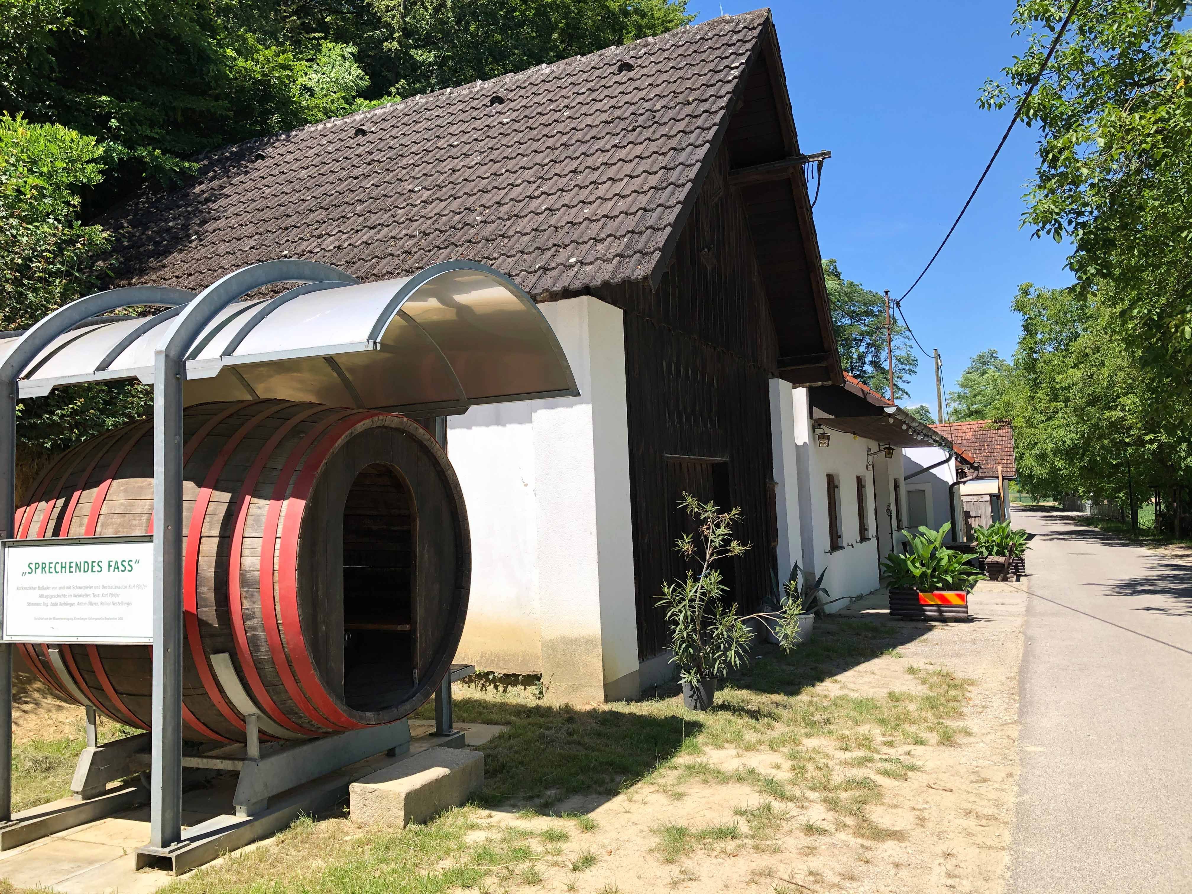 Wine tavern with large barrel and covered entrance.