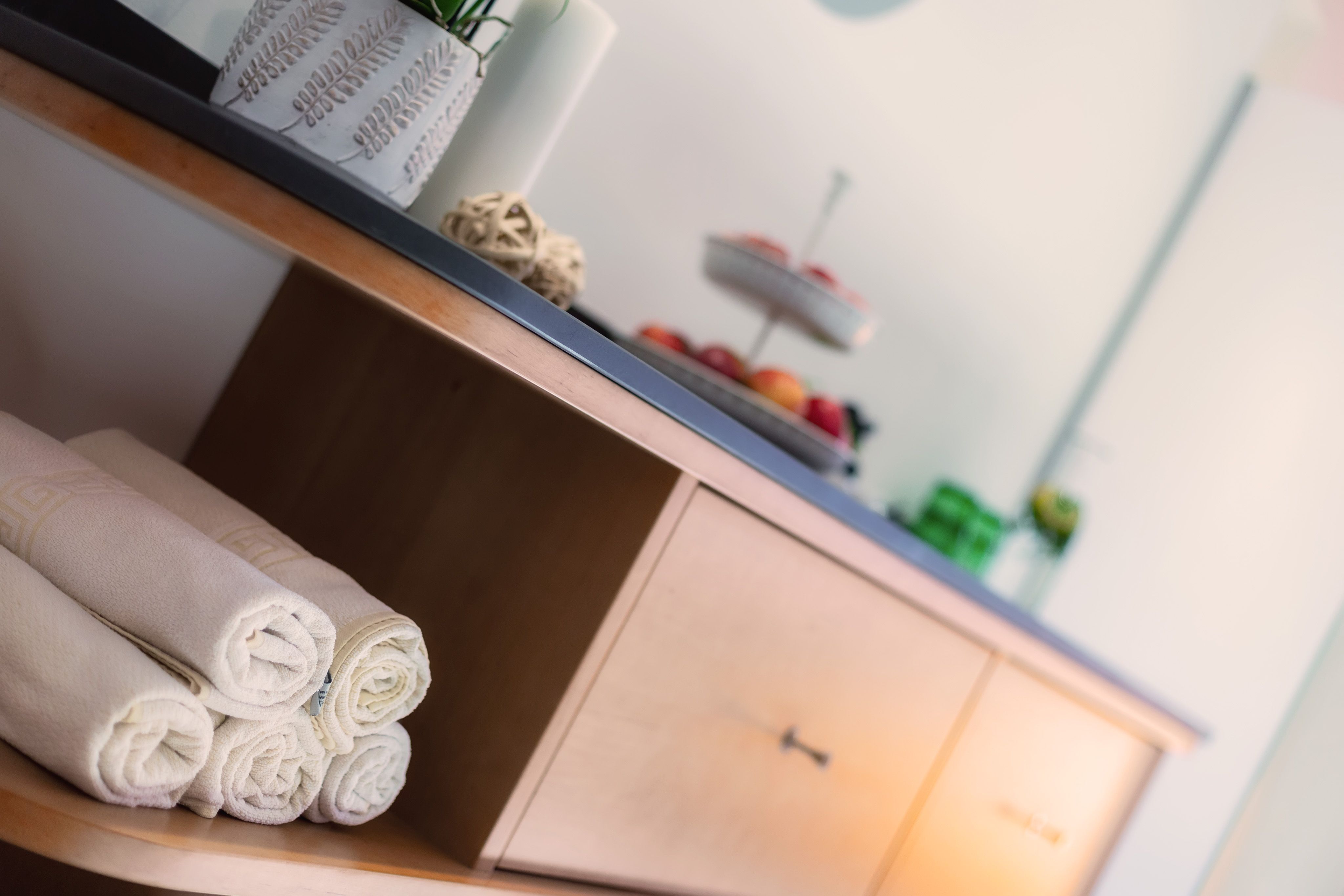 A wellness area with towels and a buffet with fruit.