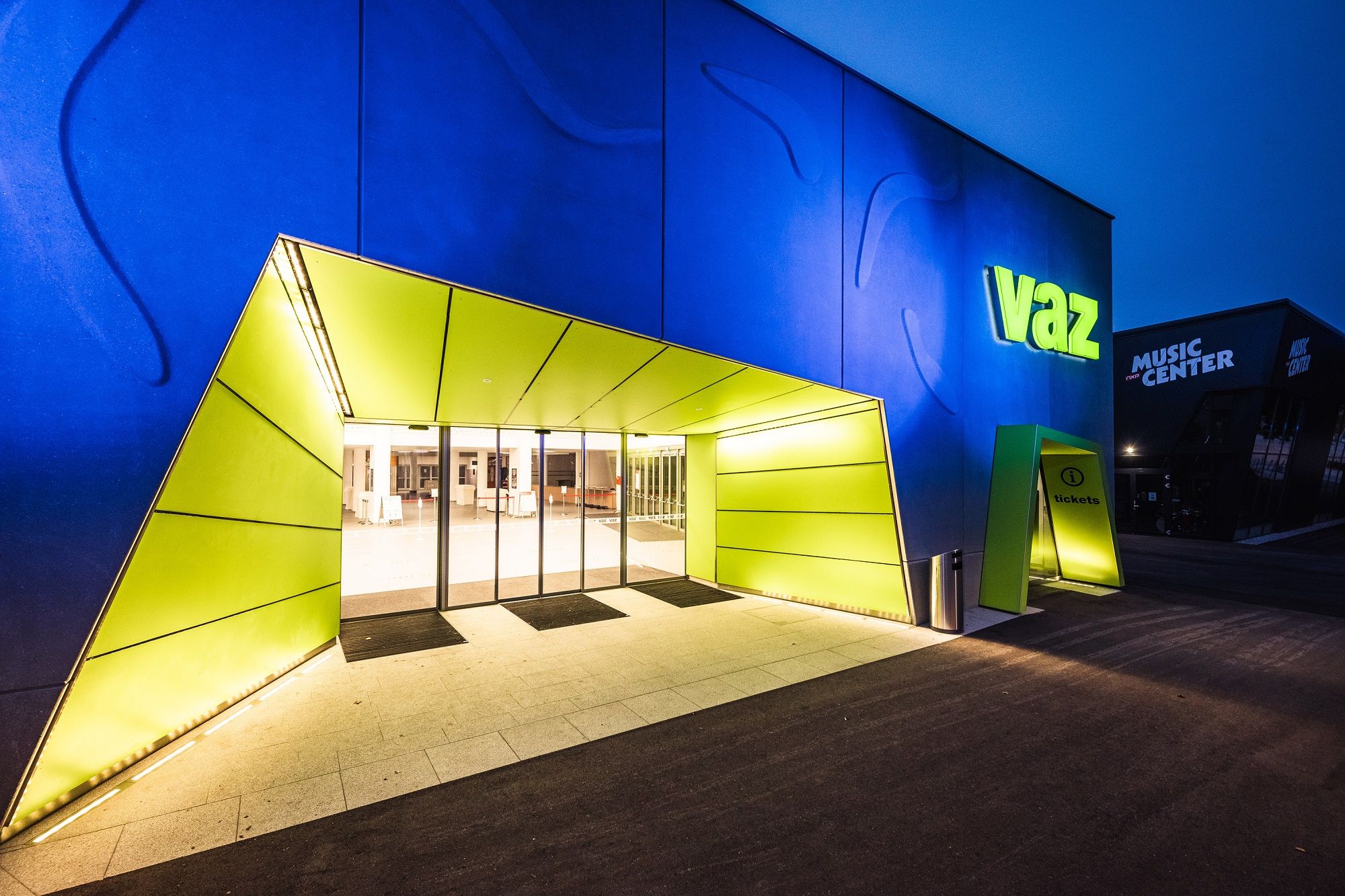 Entrance to the VAZ St. Pölten with illuminated sign and modern architecture.