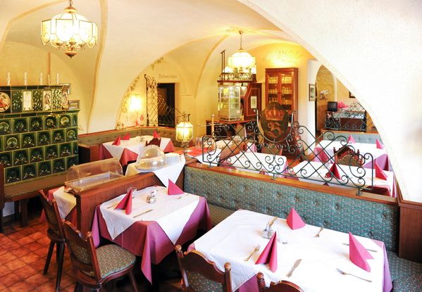 Cozy dining room with laid tables and traditional decoration.
