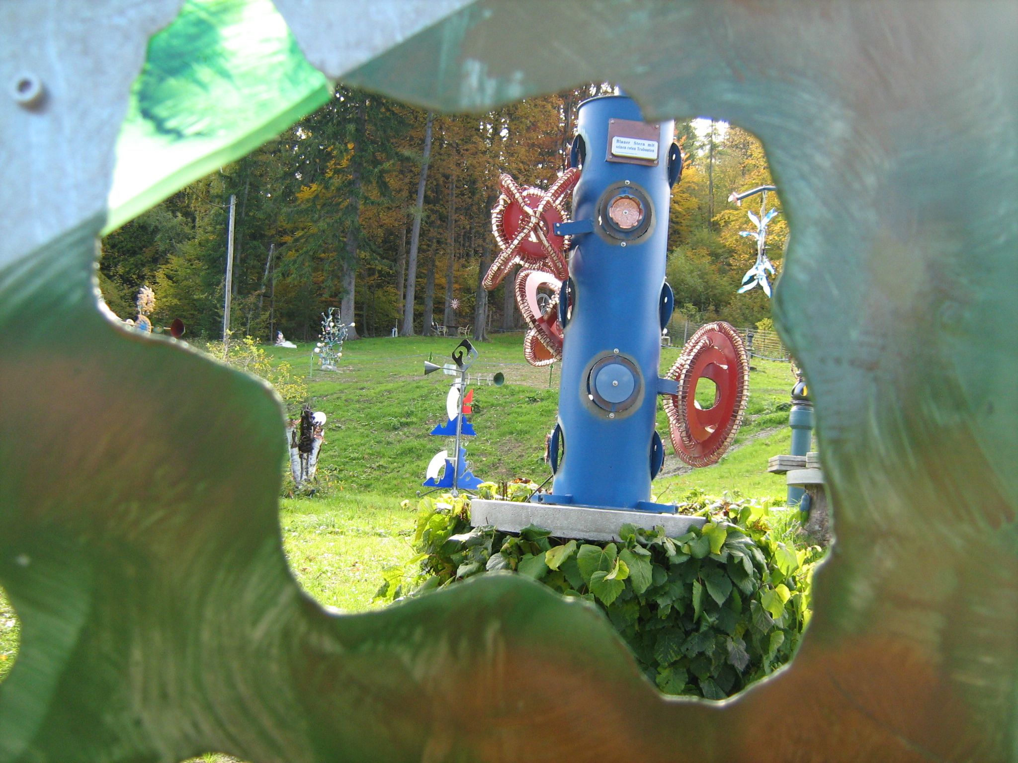 Colorful sculptures in the Semmering Sculpture Park, surrounded by a green landscape.