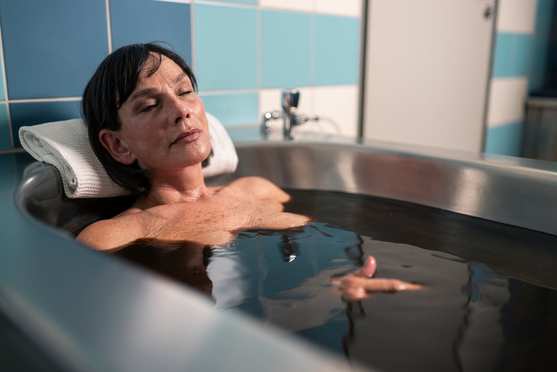 A patient relaxes in a mud bath at the Harbach Mud Baths in the Waldviertel region.