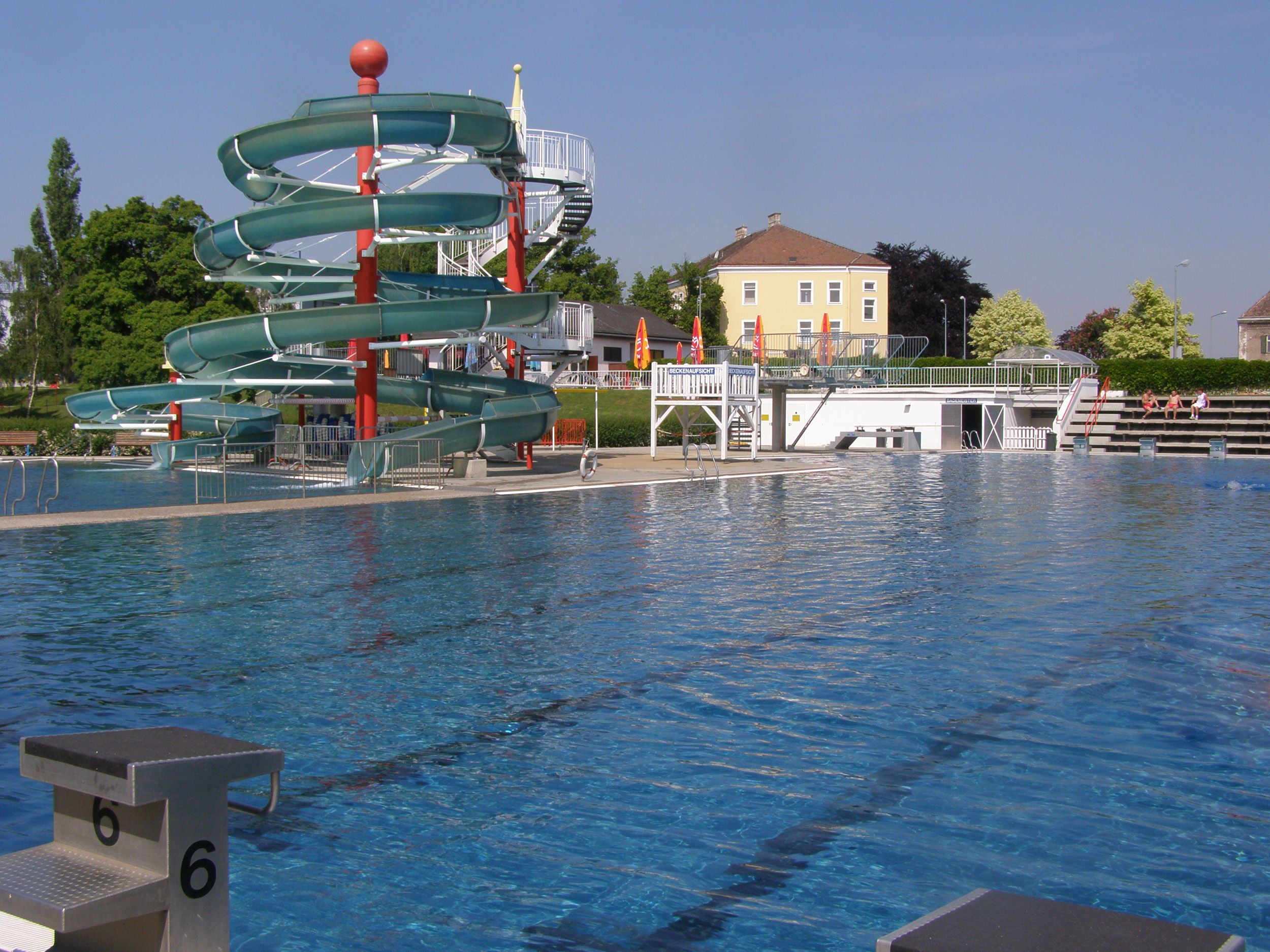 Outdoor pool with large water slide and swimming pool.