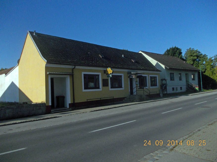 Exterior view of a yellow inn on a street dated 24.09.2014.