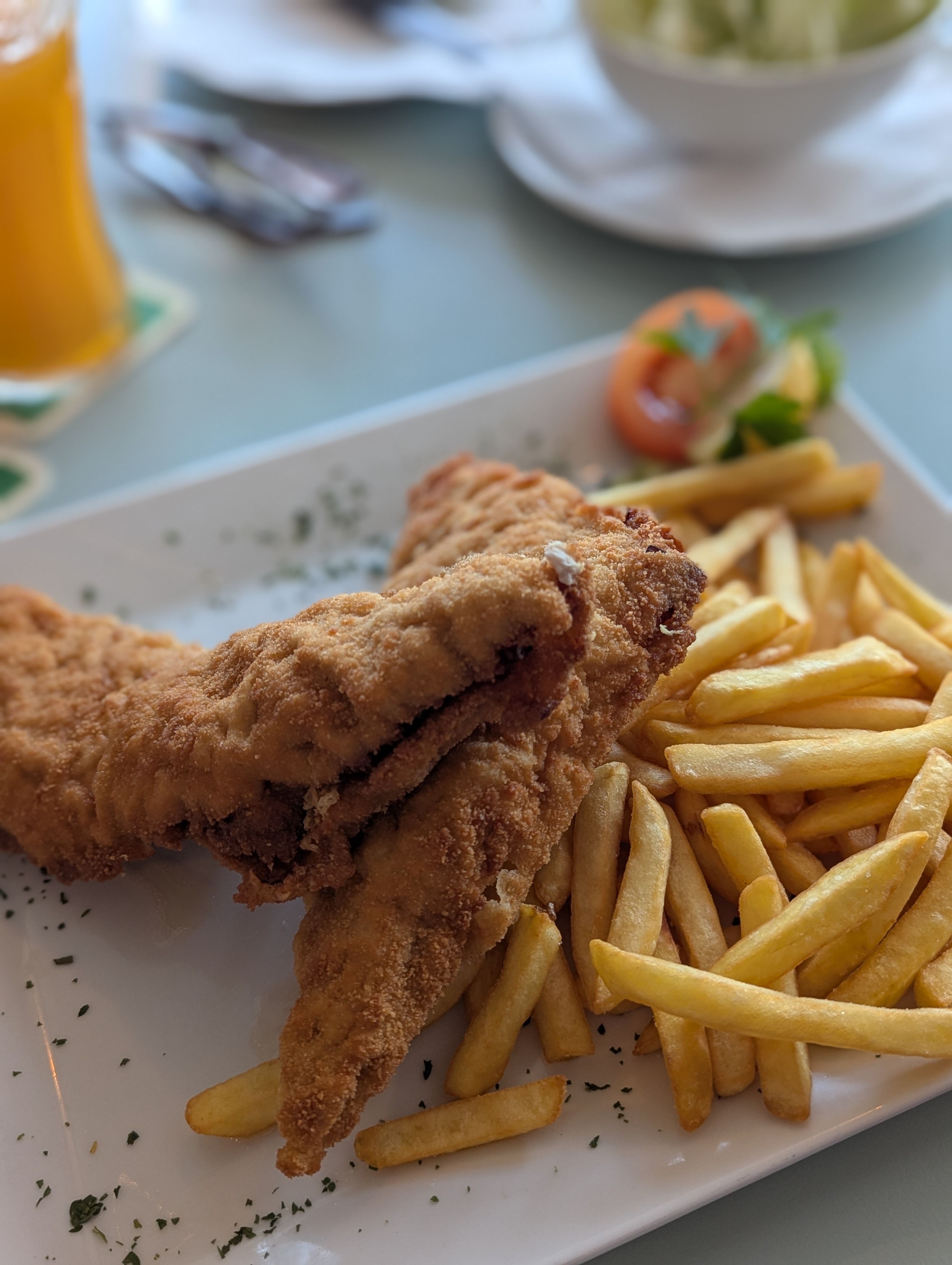 Schnitzel and fries on a white plate