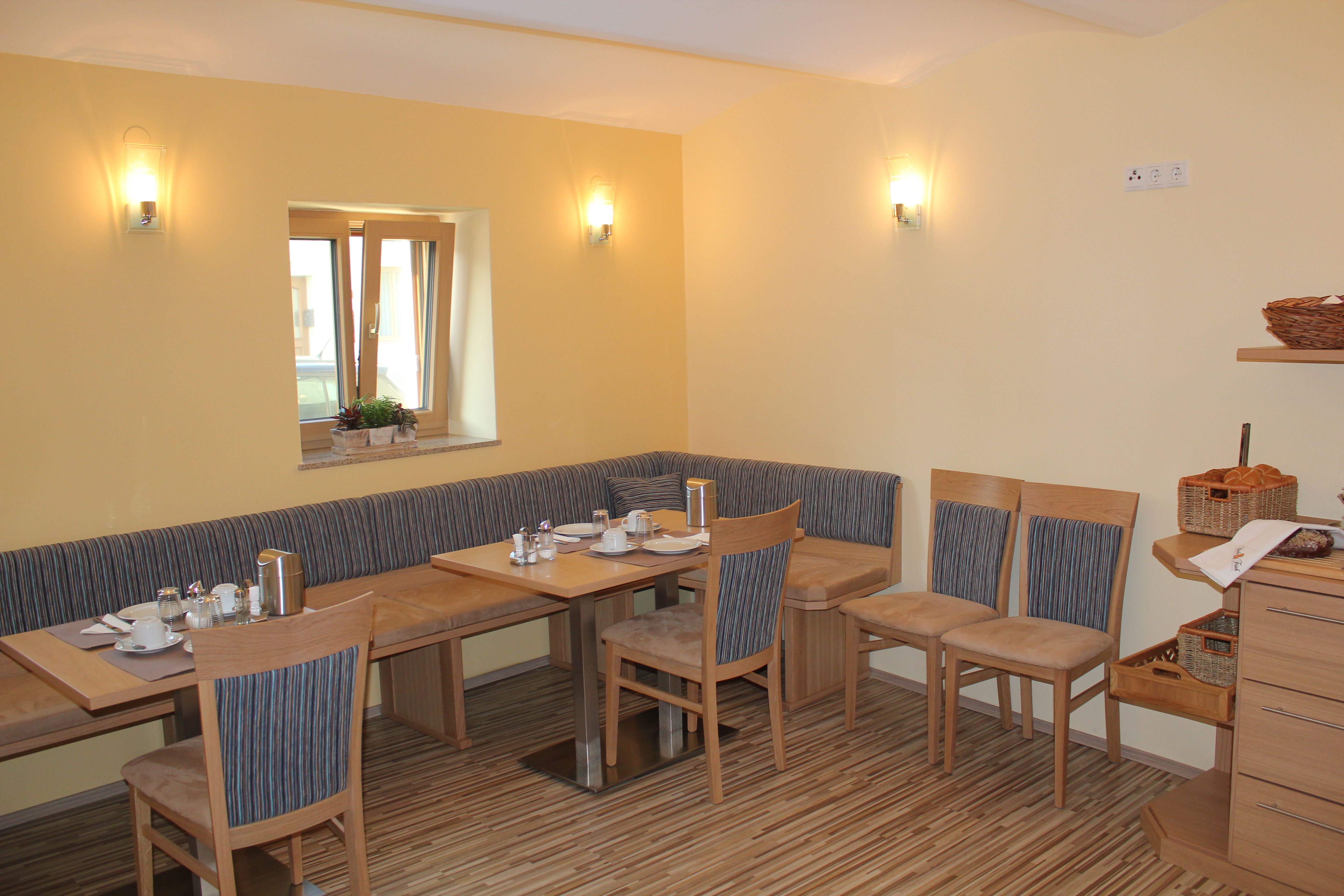 Cozy breakfast room with wooden furniture and table setting.