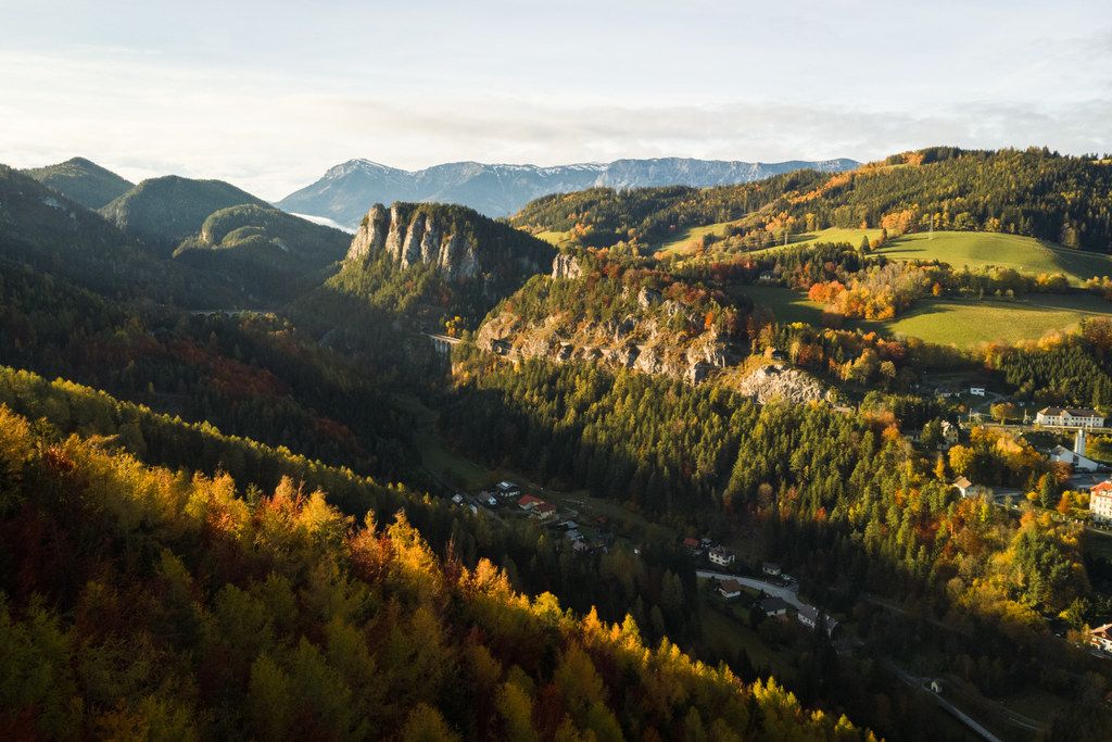 Aerial view of the Semmering Railway and Pollereswand in an autumnal landscape.