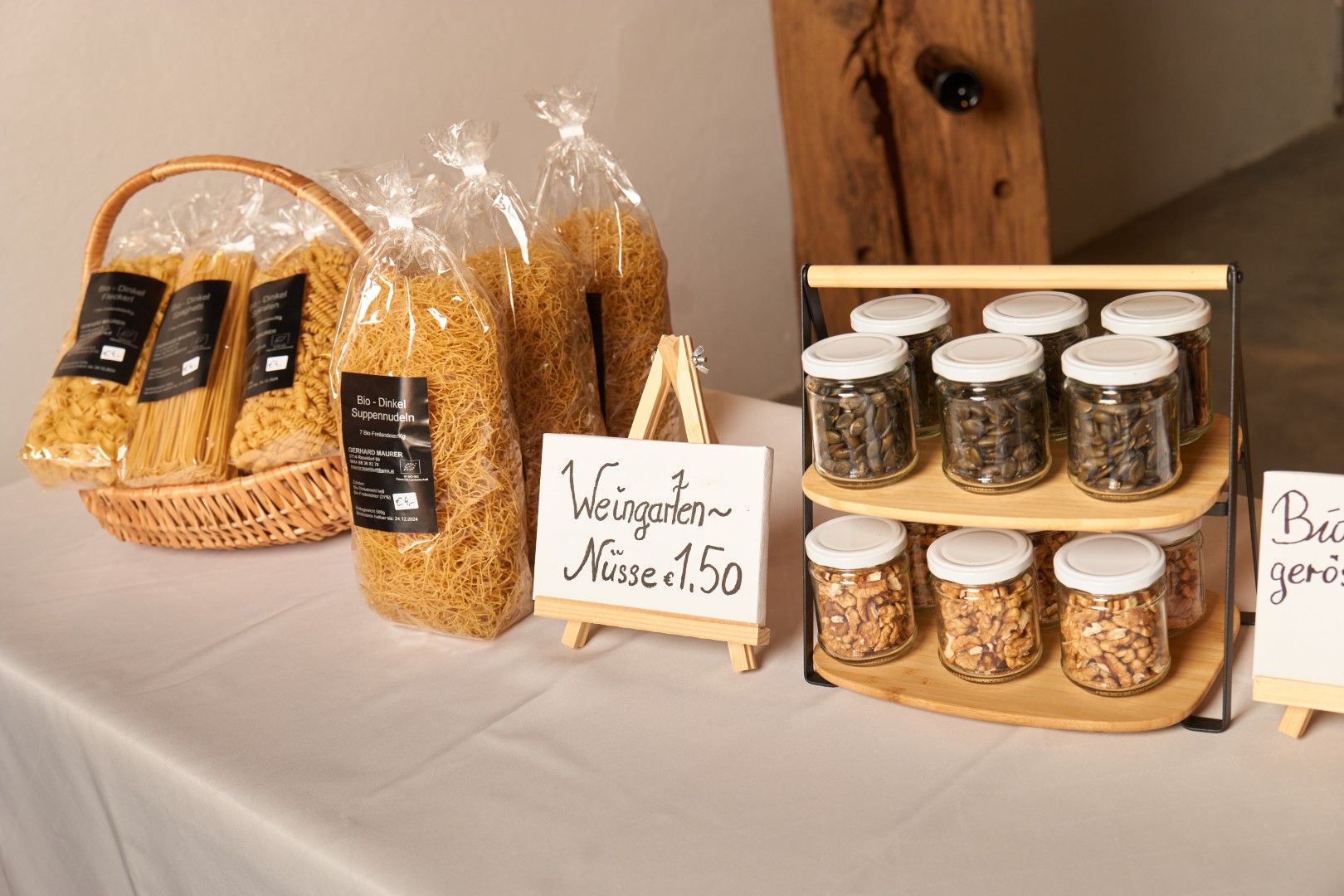A table with organic spelt soup noodles and jars of nuts.