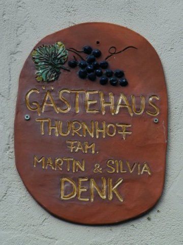 Guesthouse Thurnhof sign with grape motif.