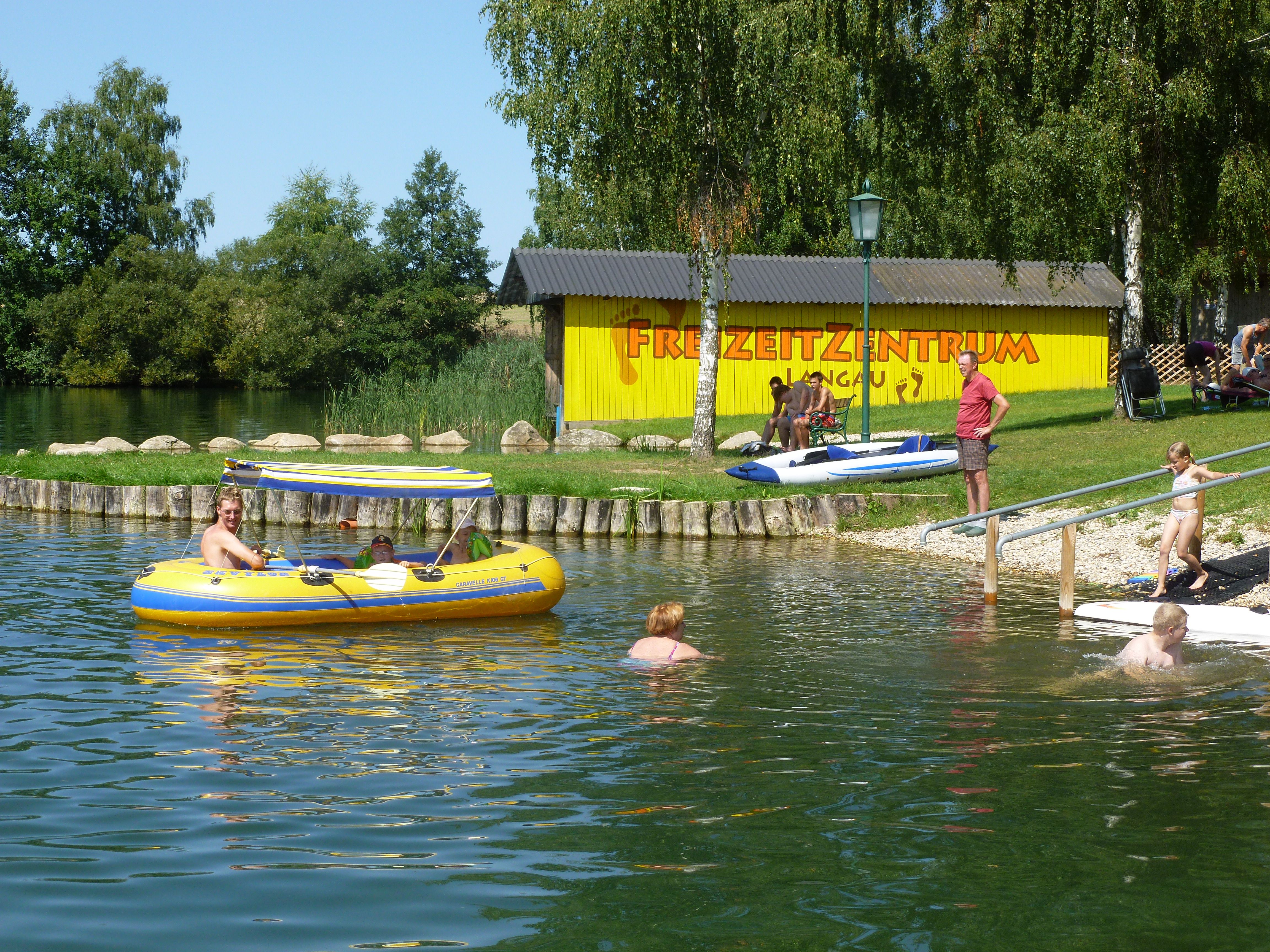 People enjoy a sunny day at the lake in the Langau leisure center.