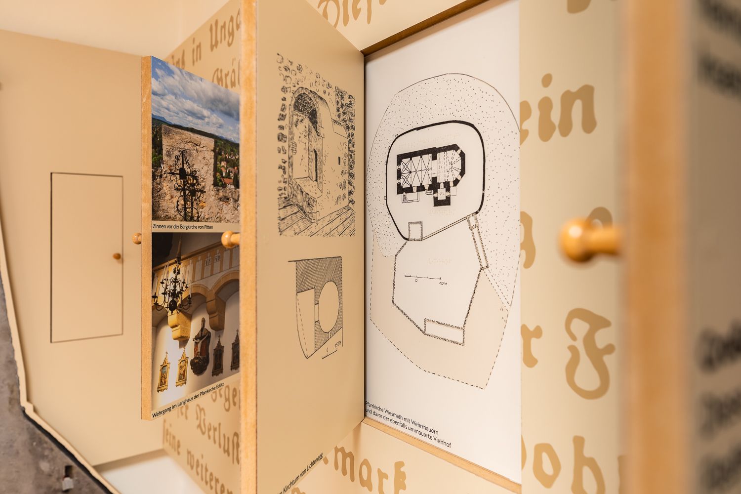 Close-up of an exhibition on fortified church documentation with drawings and photos.