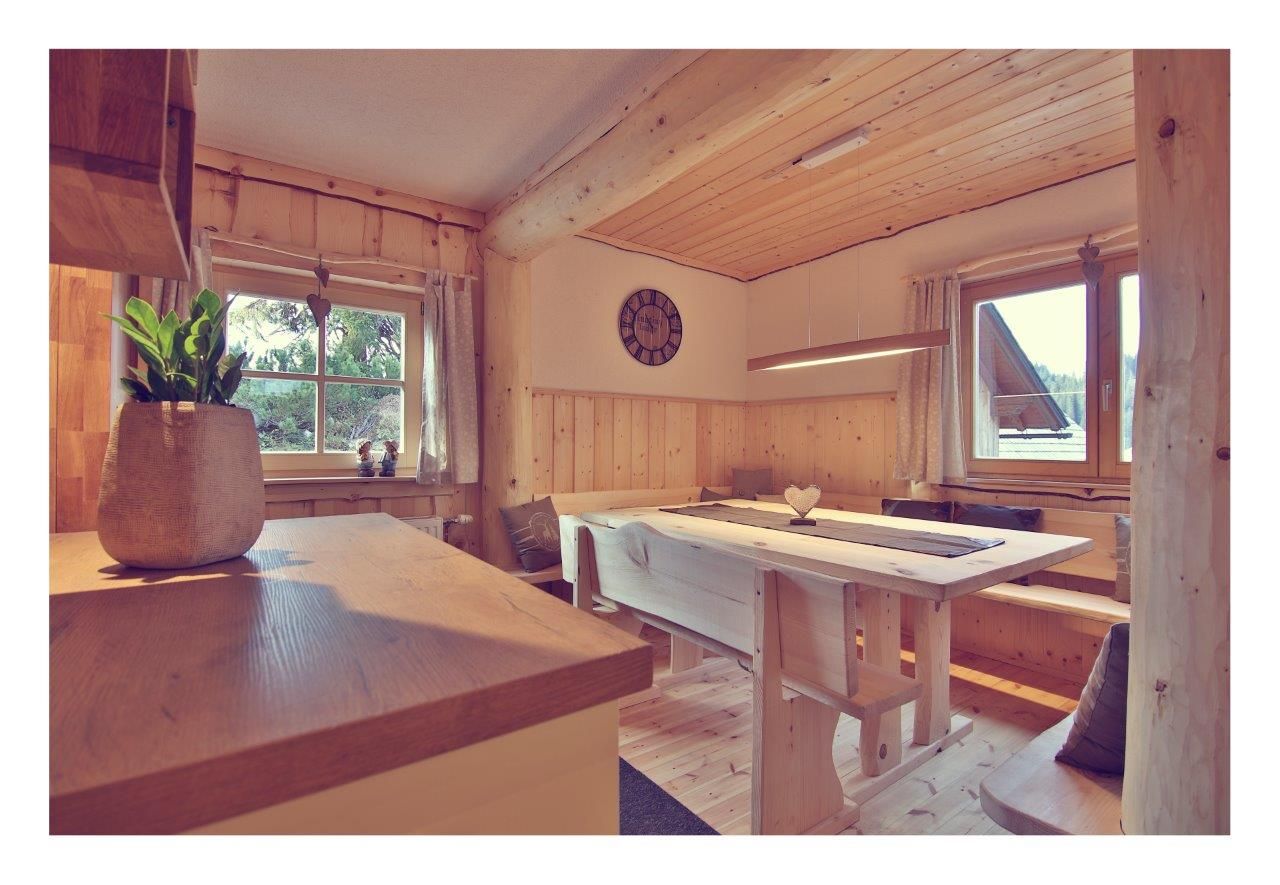 Interior view of a cozy chalet with wooden furniture and decoration.