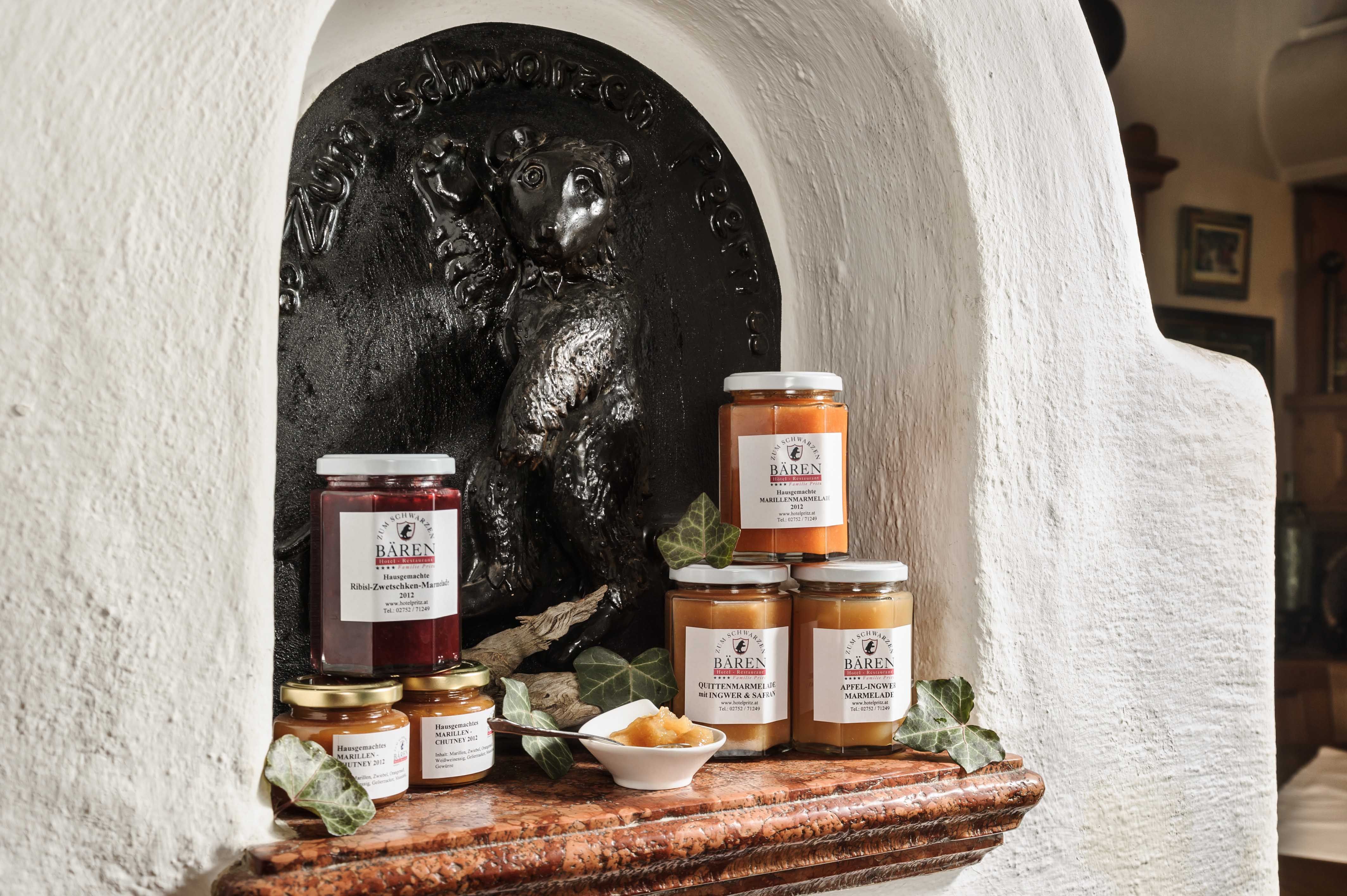 Various jam jars in front of a bear relief