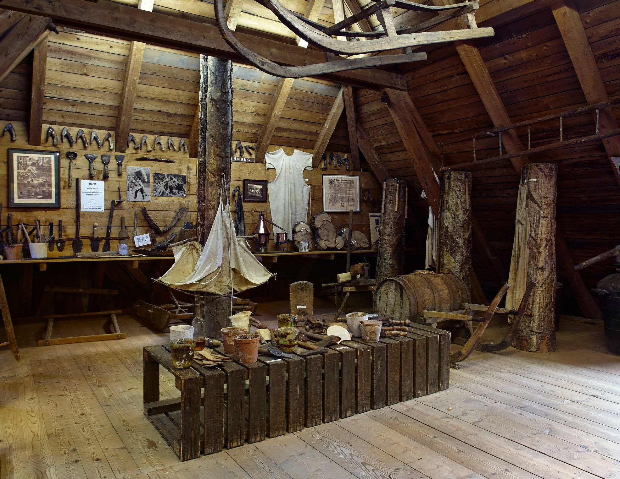 Interior view of the Gutenstein Forest Farmers' Museum with old tools and wooden objects.