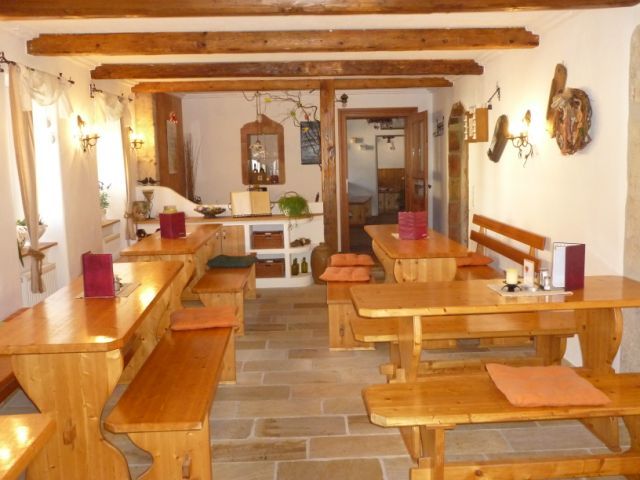 Interior view of a traditional wine tavern with wooden tables and benches.
