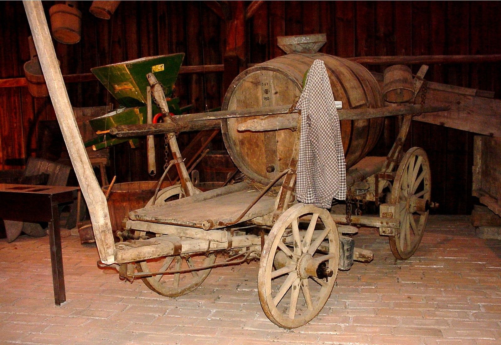 Old wooden carriage with barrel in a museum.
