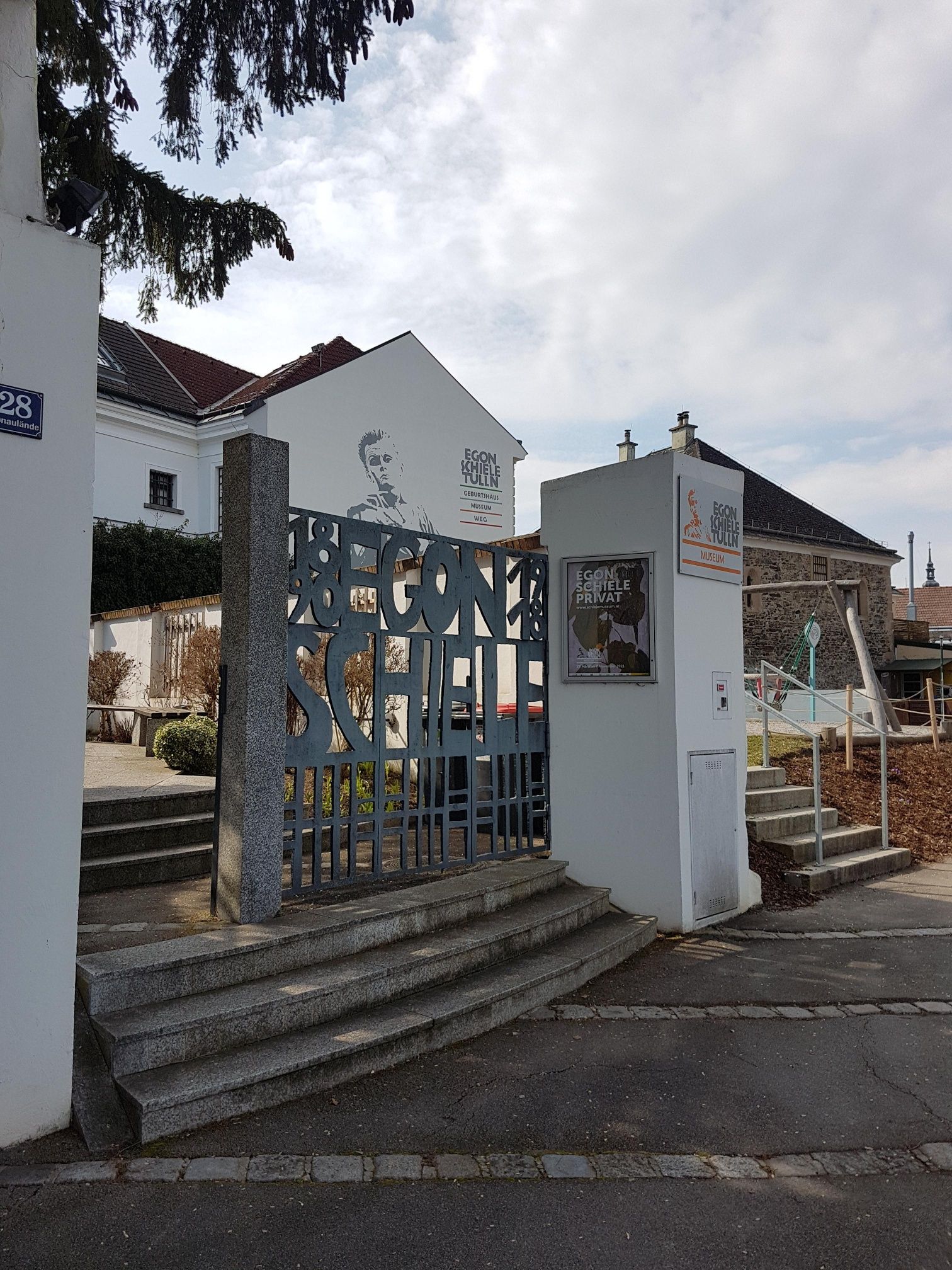 Entrance to the Egon Schiele Museum with gate and building façade.