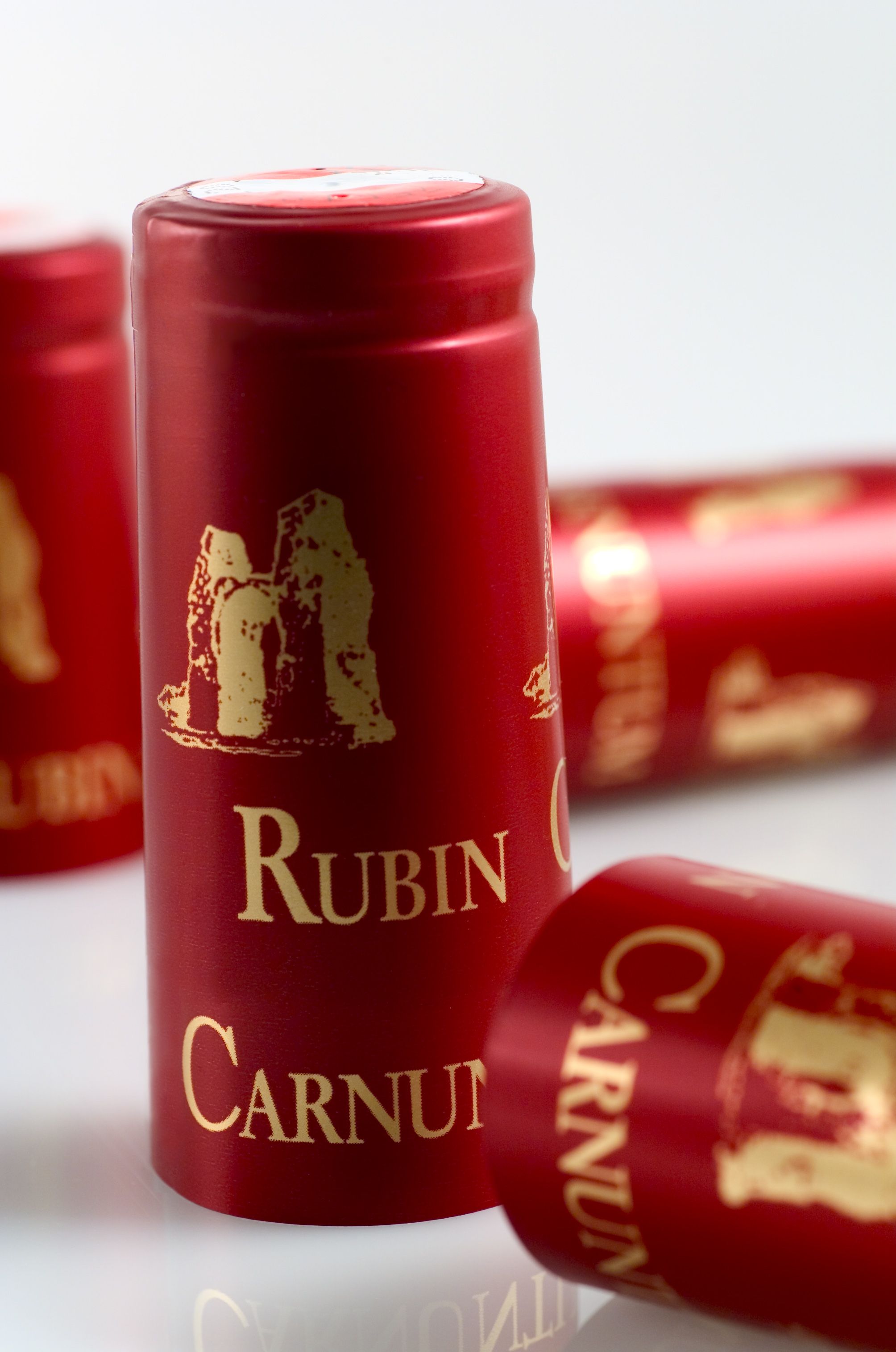 Close-up of red wine capsules labeled 'Rubin Carnuntum'.