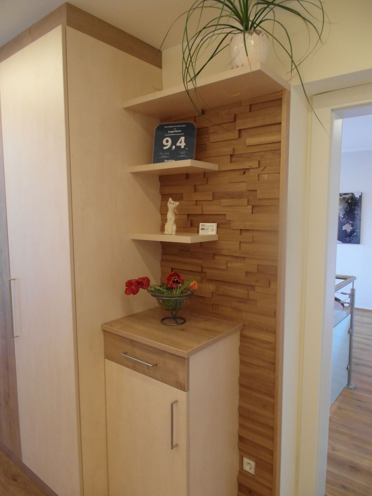 Wooden cabinet with shelves, plants and decorations.