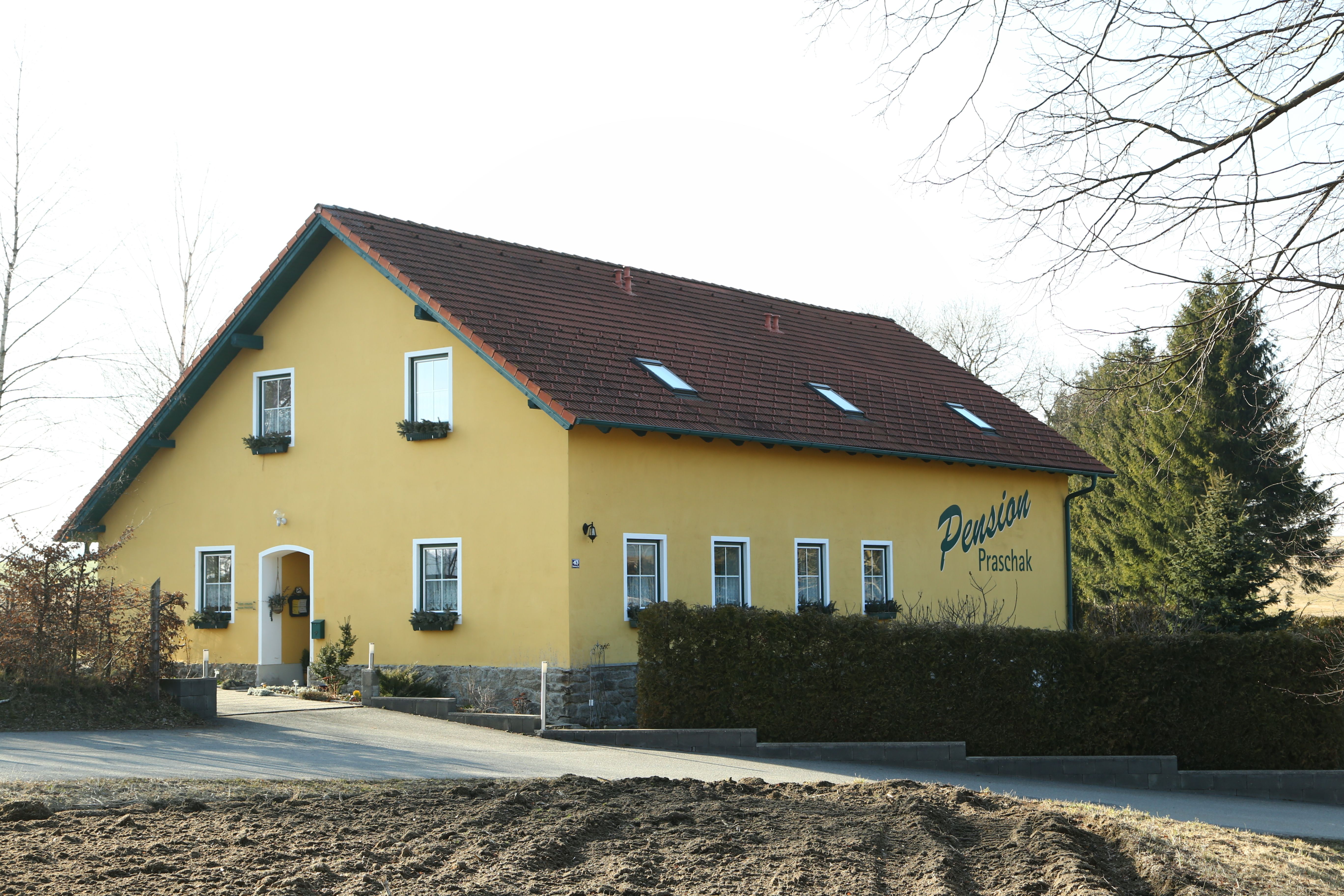 Yellow building with the inscription 'Pension Praschak'.