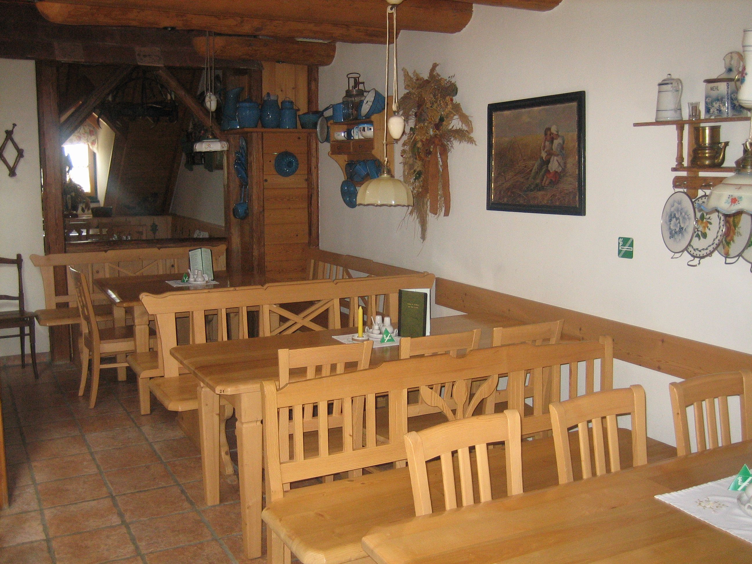 Interior view of a traditional dining room with wooden furniture and rustic decoration.