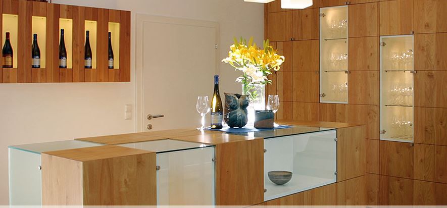 Bright tasting room with wooden table and seating, quiet atmosphere for wine tastings in a modern, rustic ambience.