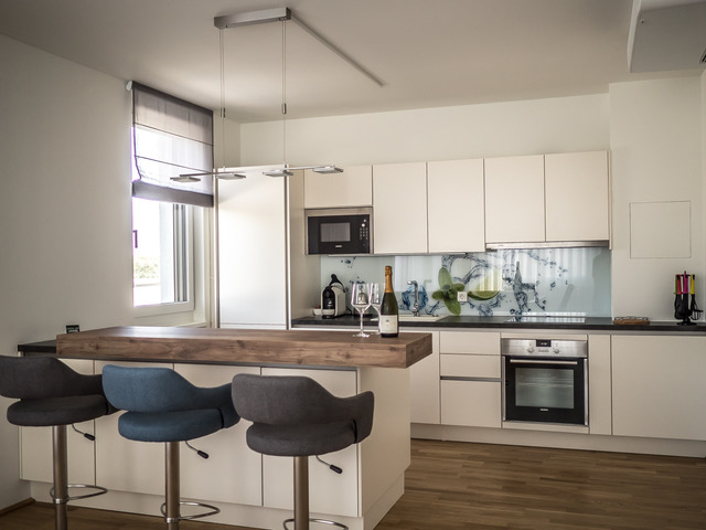 Modern kitchen with adjoining bar and window 