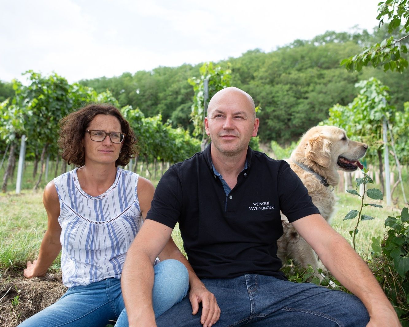 Couple with dog in the vineyard