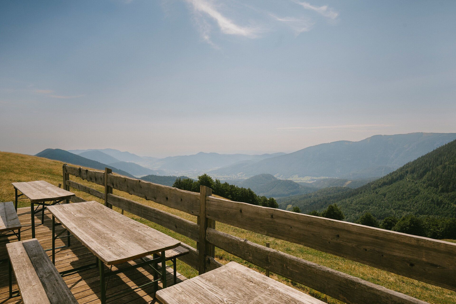 Benches offering panoramic views of the mountain landscape near the Almreserlhaus on the Schneeberg