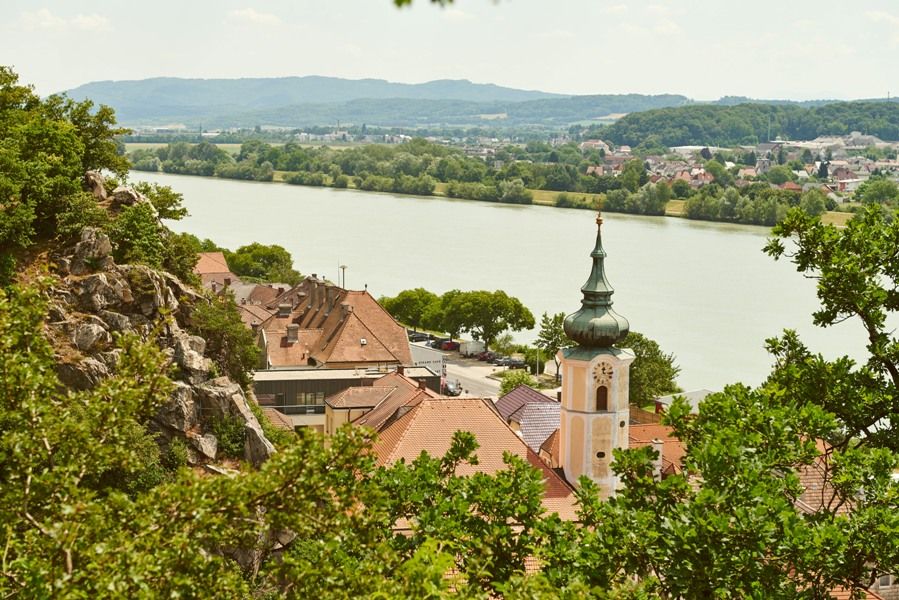 View of Marbach on the Danube in summer with church and river.