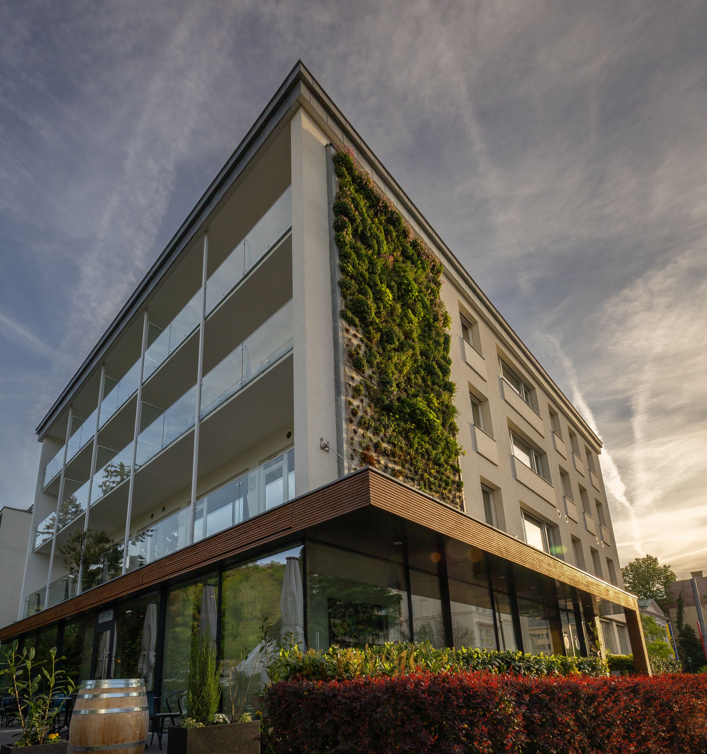 Modern hotel building with vertical garden wall and glass façade.