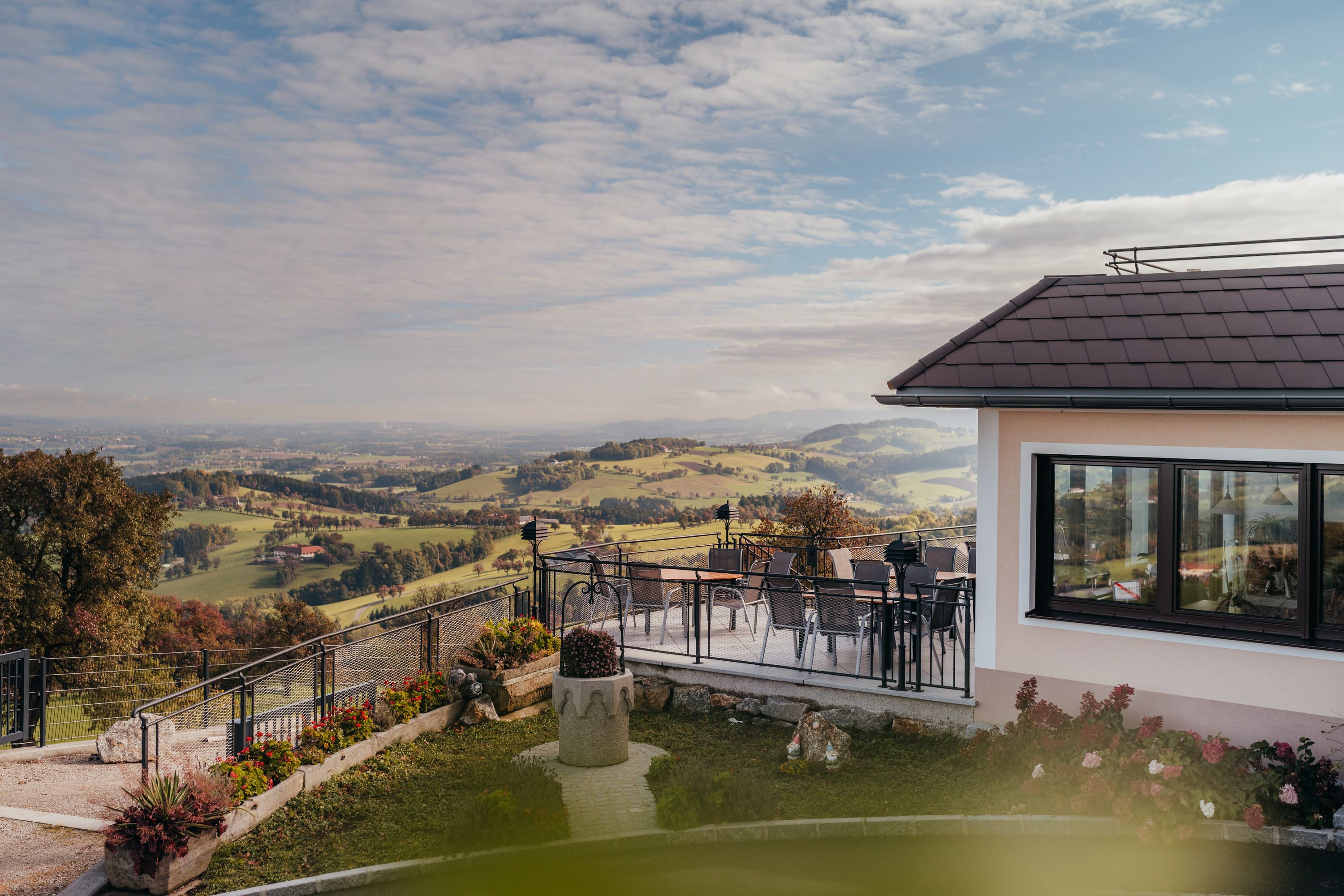 Panoramic view from an inn in St. Peter in der Au with terrace and landscape.