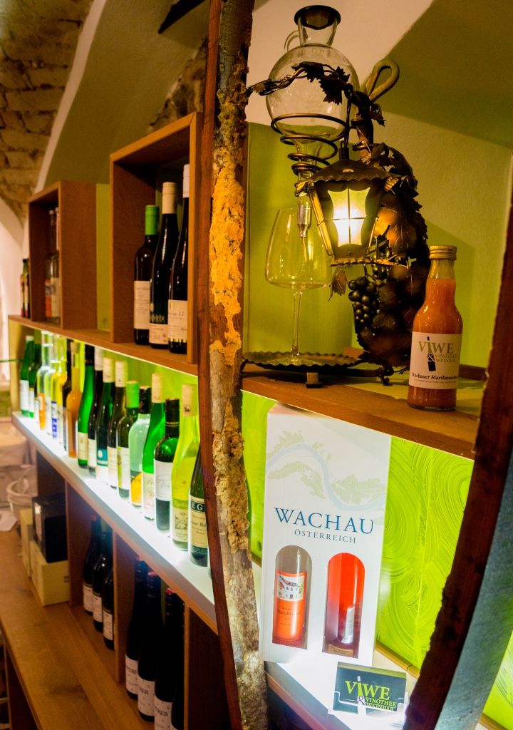 Shelf with wine bottles and decoration in a wine bar.