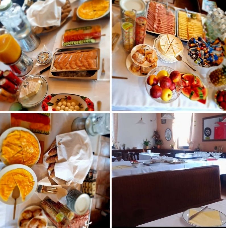 A rich breakfast buffet with various dishes and drinks on one table.