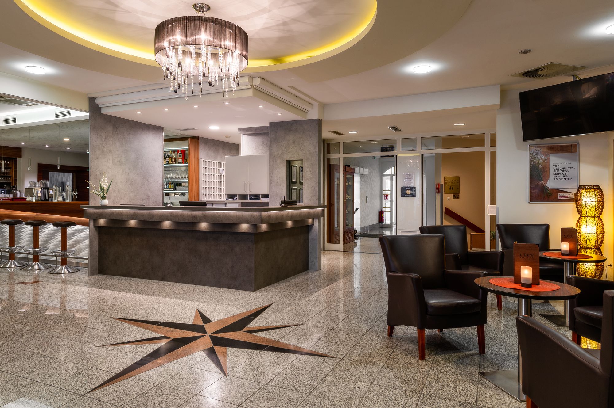 Hotel reception with bar and seating area.