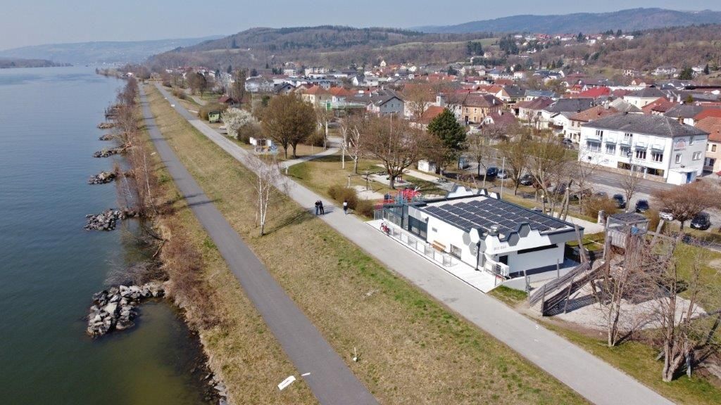 Aerial view of a bar on the Danube with surrounding landscape and buildings.