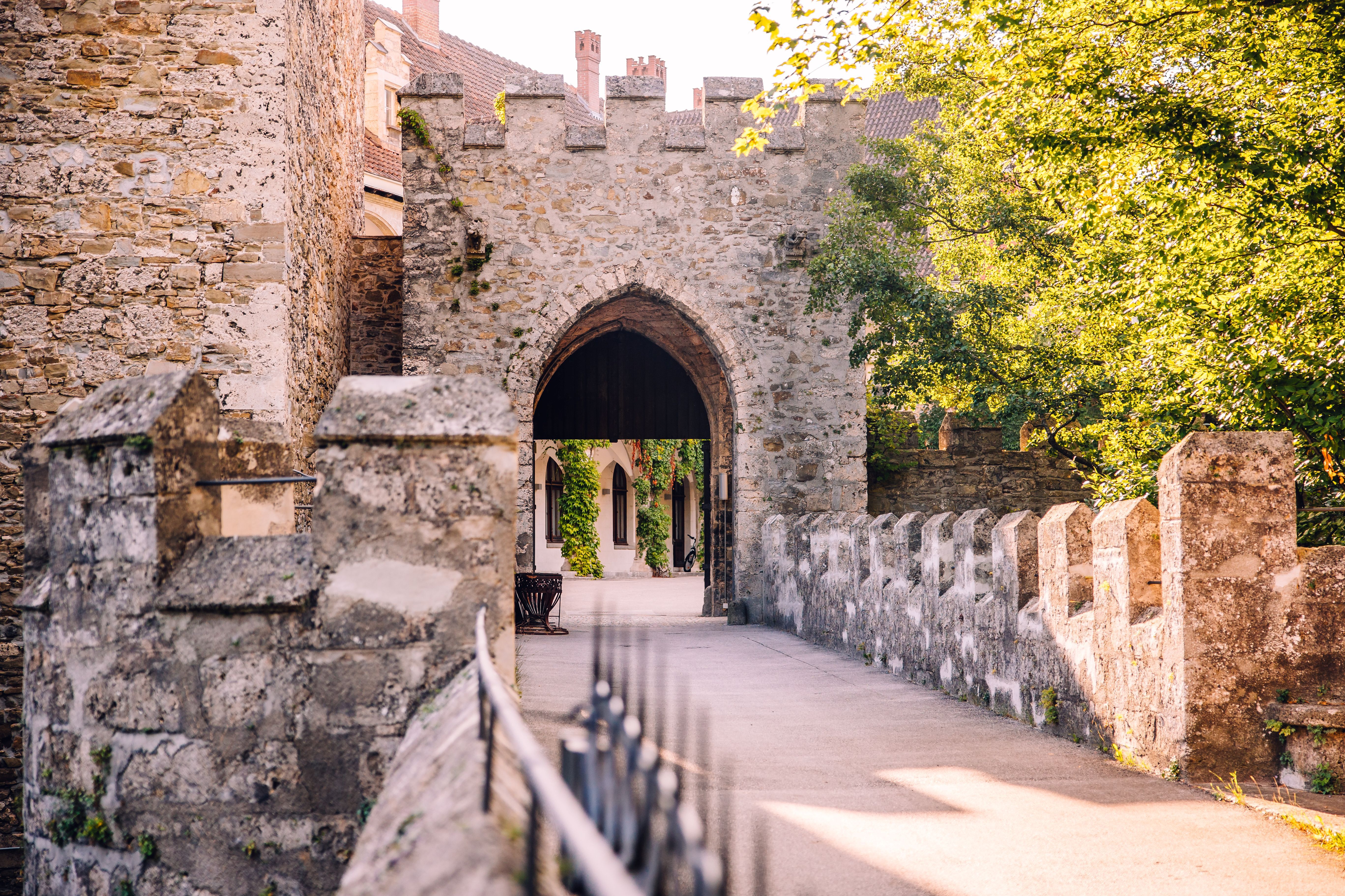 A historic stone bridge with battlements and an archway at the entrance to Schloss Rothschild in Waidhofen an der Ybbs.