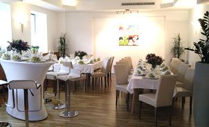 Elegant room with laid tables and chairs.