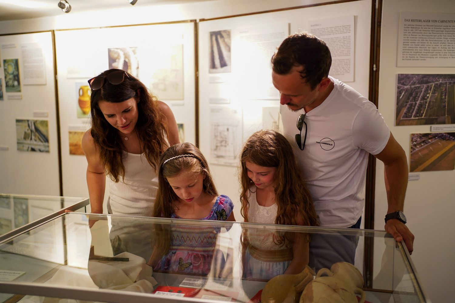 A family looks at exhibits in a museum.