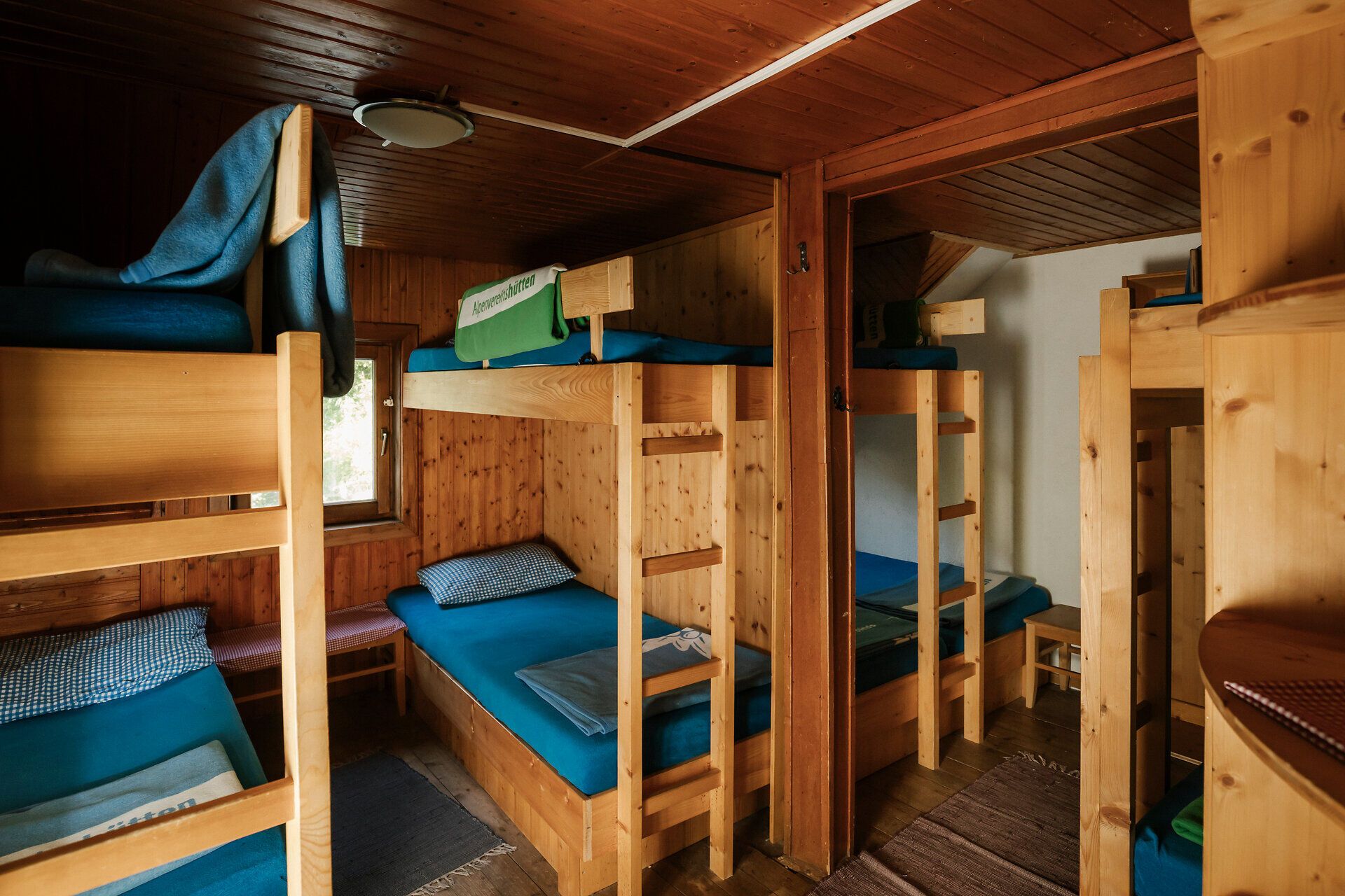 Dormitory room with wooden bunk beds at the Edelweißhütte on Schneeberg