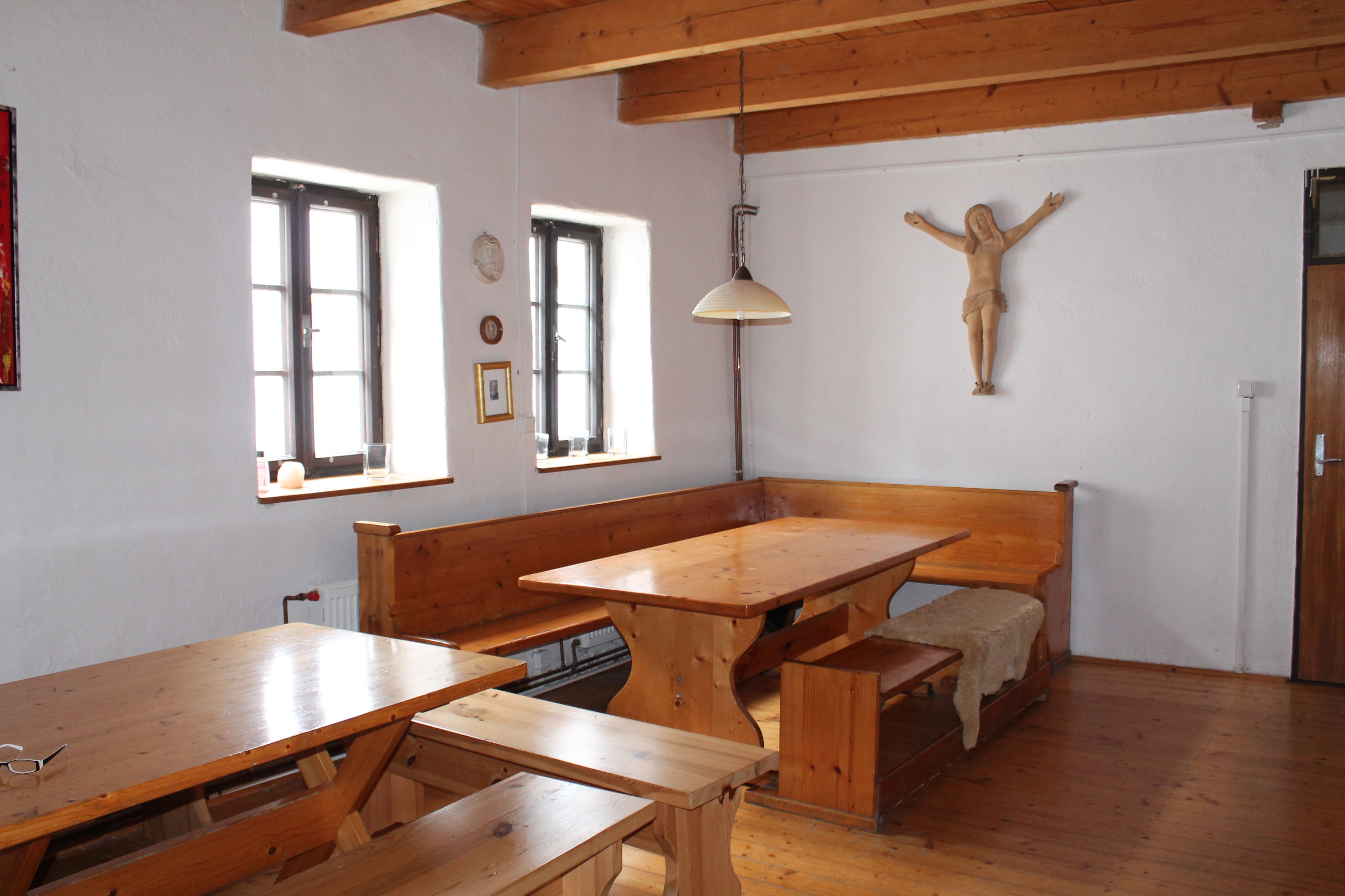 Rustic room with wooden furniture, wooden beamed ceiling and wall decoration.